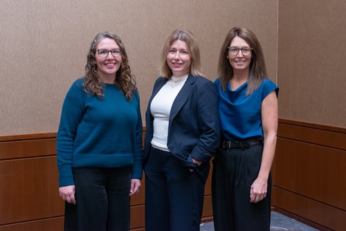 Three Newfoundland and Labrador Health Services team members standing together and smiling.