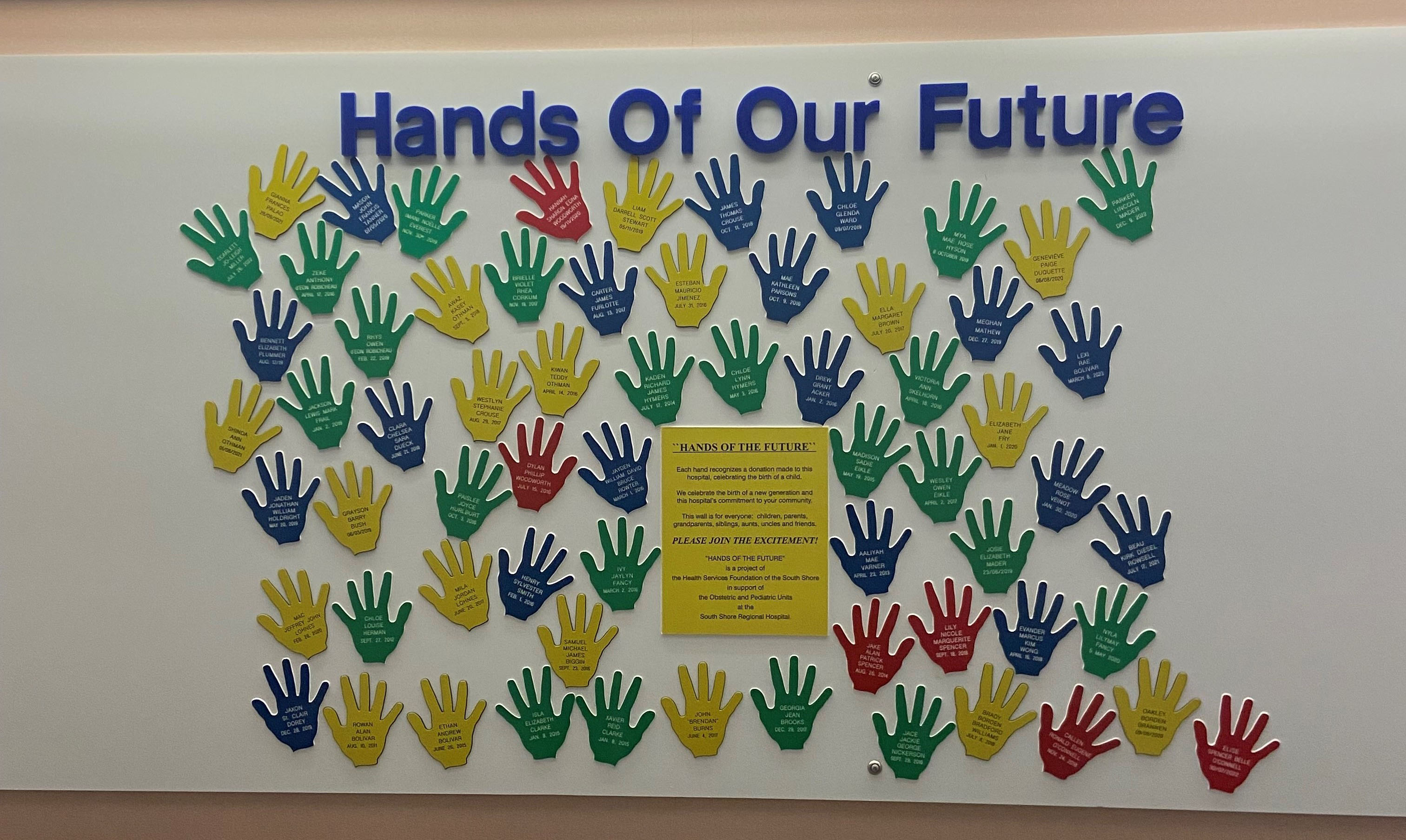 A display titled "Hands of Our Future" features colorful hand-shaped cut-outs with messages by patients and staff, arranged on a wall on the Women and Children’s unit at South Shore Regional Hospital in Bridgewater, N.S.