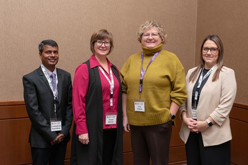 Four Health Sciences North Sudbury team members posing together and smiling.
