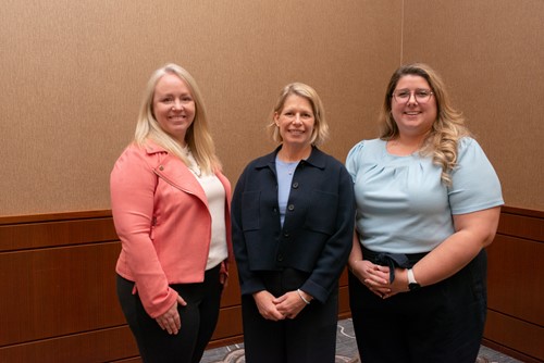 Three Unity Health Toronto team members standing together and smiling.